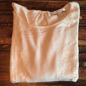Cream sweater with lace detail.